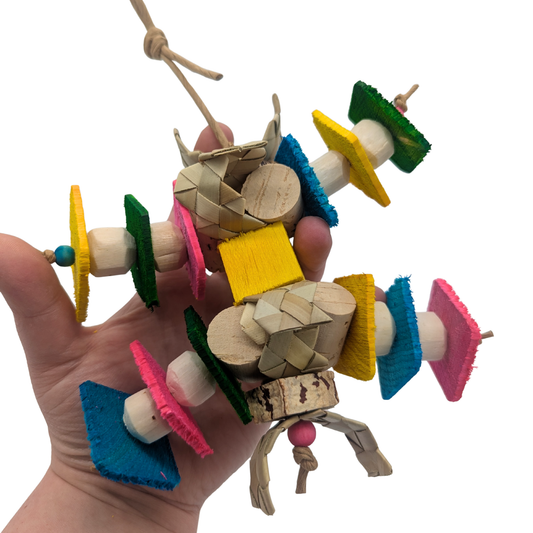 Hodgepodge Lite by Lil Monsters Bird Toys. Held in hand for scale.