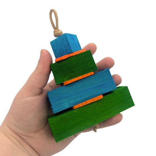Balsa Birthday Cake by Lil Monsters Bird Toys. Held in hand for scale. Blue and green color scheme.
