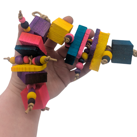 Dillan by Lil Monsters Bird Toys. Held in hand for scale.
