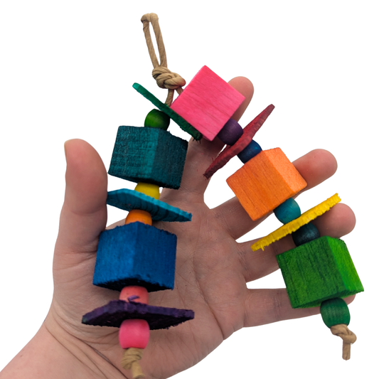 Hugh by Lil Monsters Bird Toys. This is an arched, barrel bead barrel, held in hand for scale.
