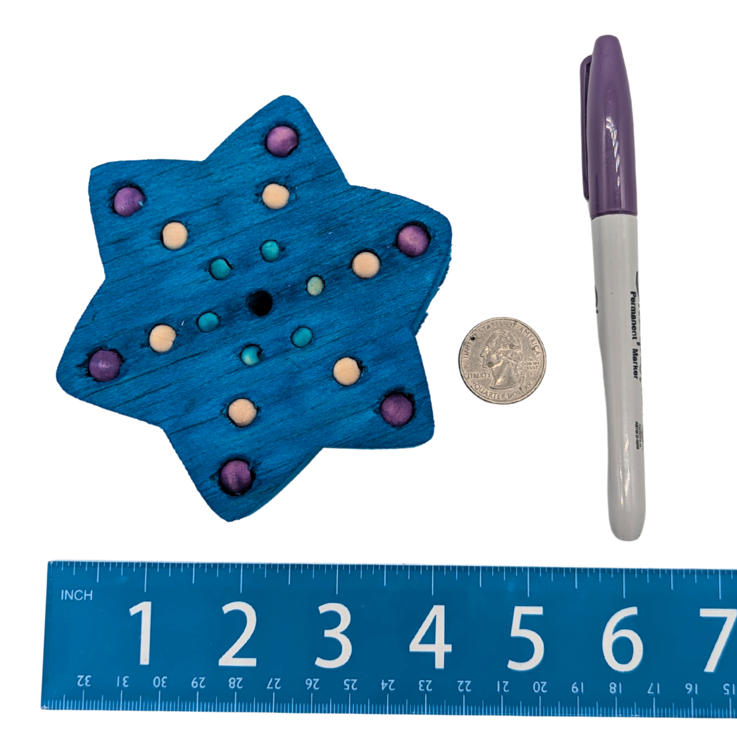 Skadi parrot toy by Lil Monsters Bird Toys, next to a sharpie, ruler, and US quarter for scale