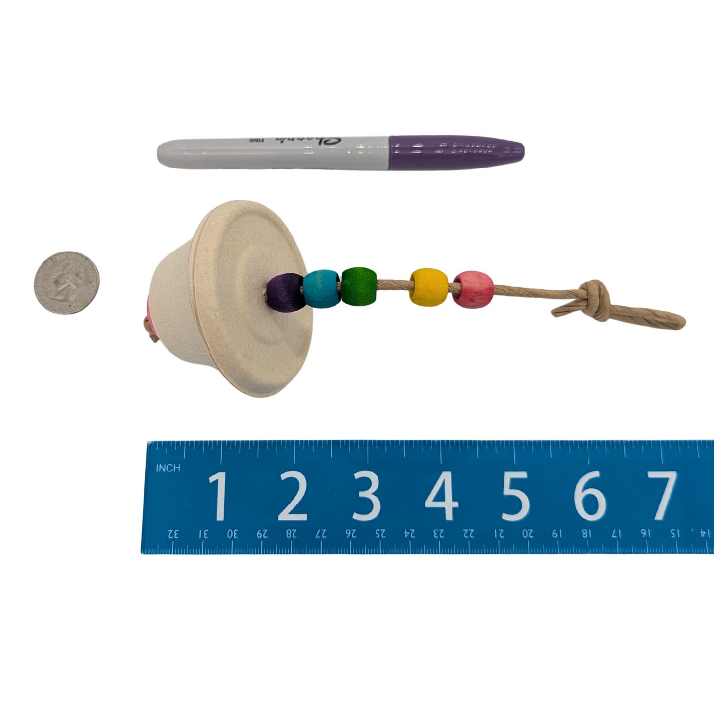 Souffle by Lil Monsters Bird Toys. Shown next to a ruler, US quarter, and sharpie marker for scale.