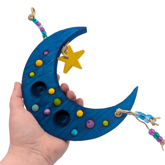 Sweet Dreams by Lil Monsters Bird Toys. A Crescent Moon Shaped Bird toy swing, held in hand for scale.