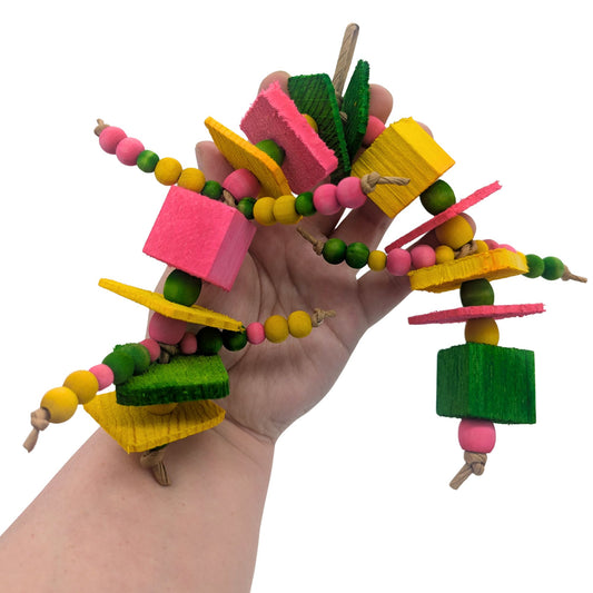 Triathlon by Lil Monsters Bird Toys. Held in hand for scale.