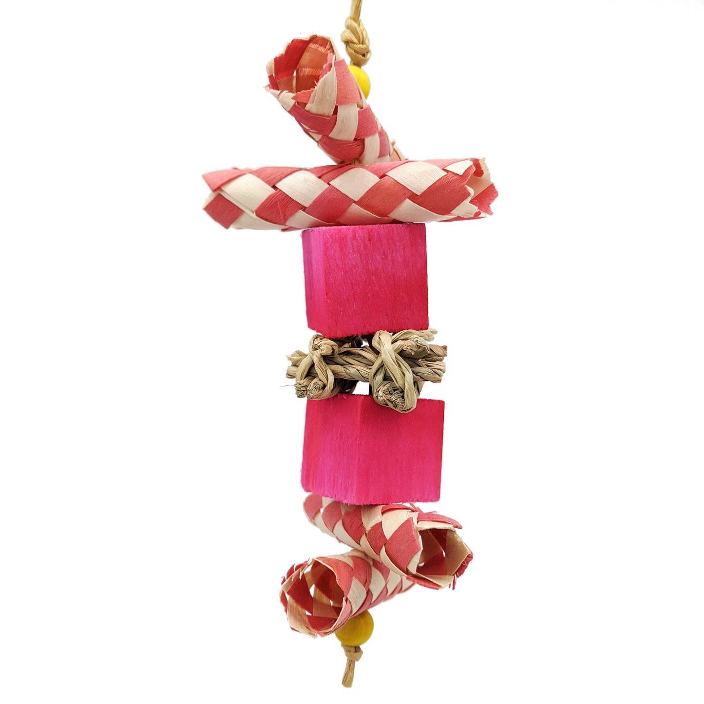 Bird toy with palm finger traps cut in half, two balsa blocks, and a piece of seagrass in the center. Pink coloration.