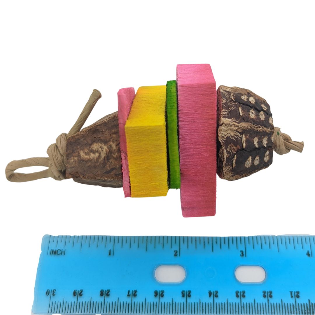 A small bird toy with two mahogany pods,, two super thin pieces of pine, and 2 balsa slats.