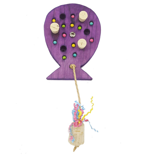 A birthday balloon shaped piece of pine, with embedded corks, wooden beads, and  string with cork weight. 