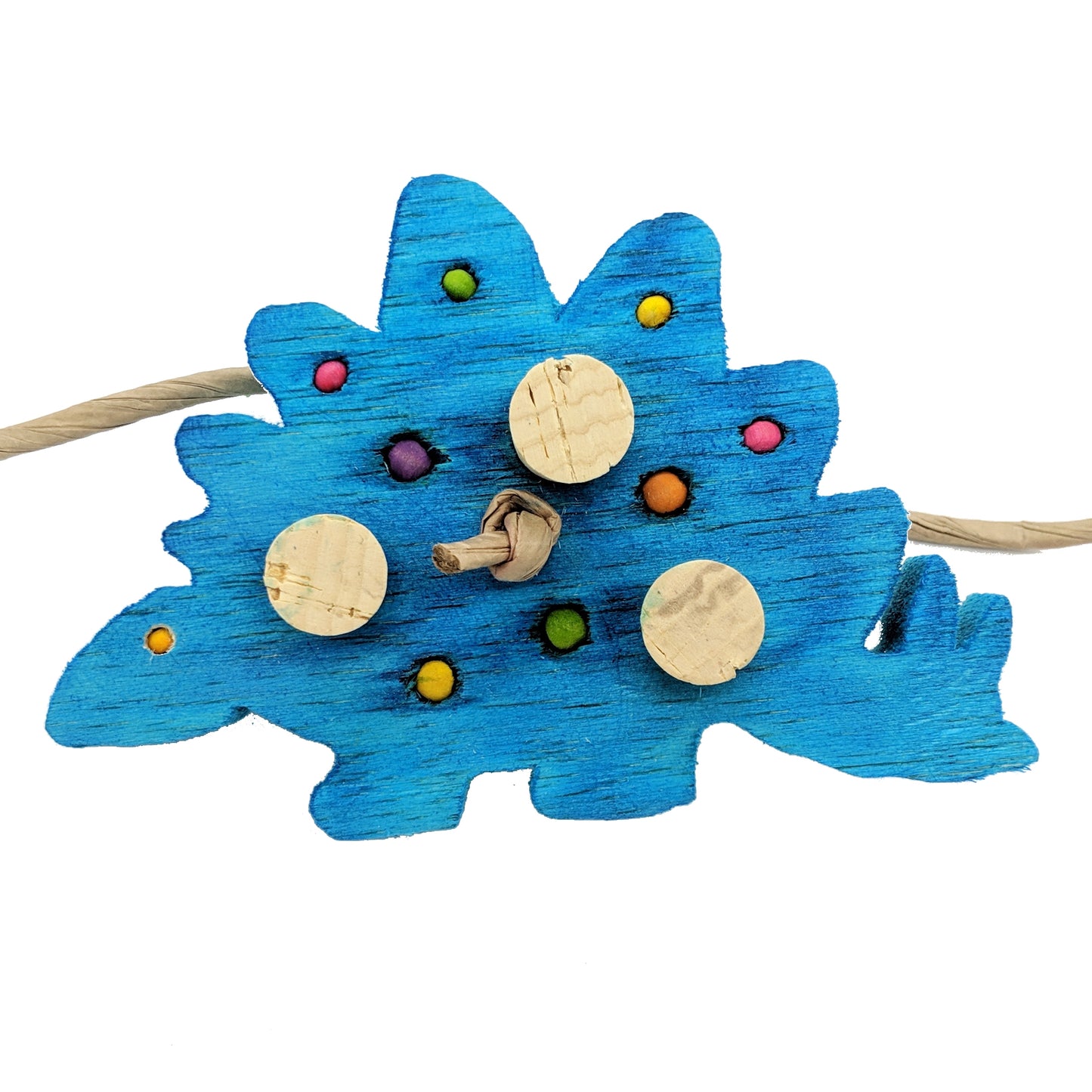 A stegosaurus shaped piece of balsa. Embedded with 4mm, 6mm, and 8mm wooden beads, and three cork stoppers.
