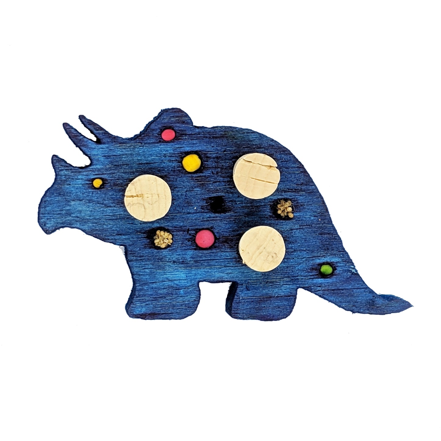 A triceratops shaped piece of balsa, with embedded corks, 4 spots for beads or millets, and 3 smaller beads.