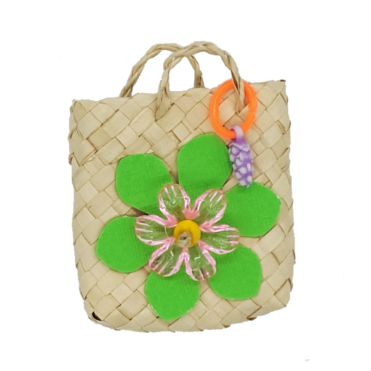 A woven palm bag with cardstock leaves, acrylic flower, and fruit charm.