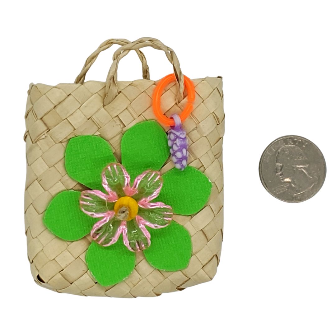 A woven palm bag with cardstock leaves, acrylic flower, and fruit charm.