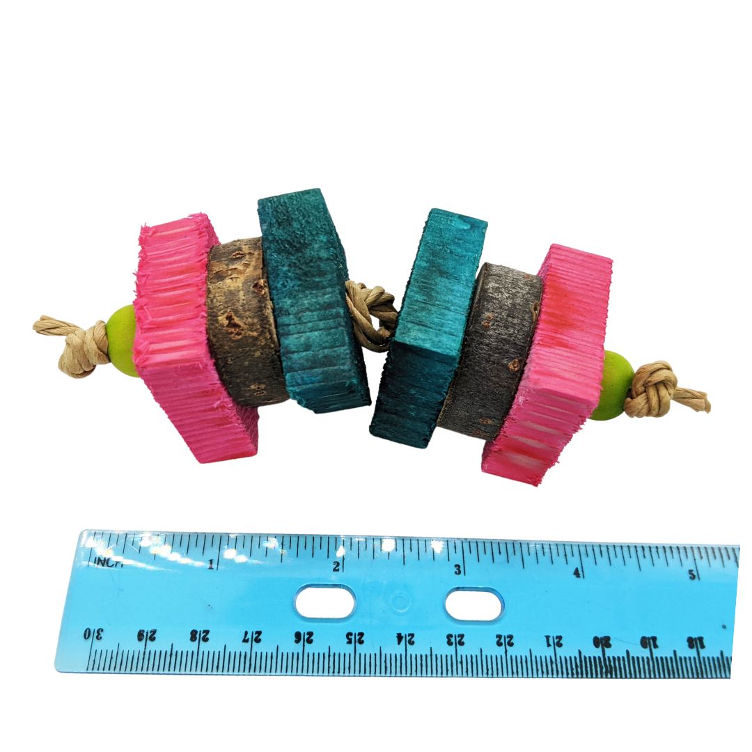A small toy on a skewer. Strung on paper rope, 4 pieces of 1/2" pine, with cottonwood coins sandwiched between them. Shown next to ruler showing 4.5" size