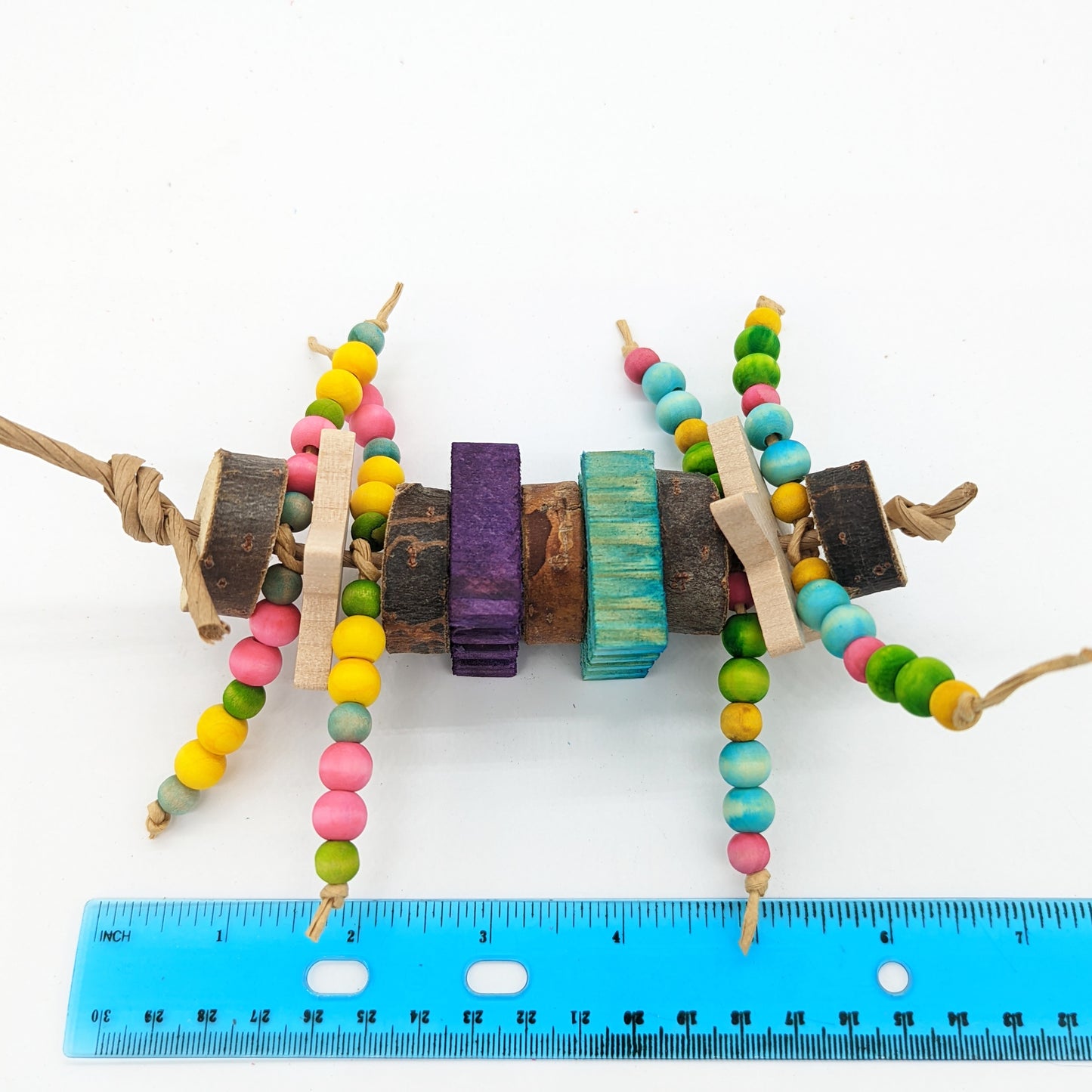 A natural wood bird toy with wooden beads, cottonwood slices, hardwood stars, and untreated kiln pine slices. For small to medium birds.