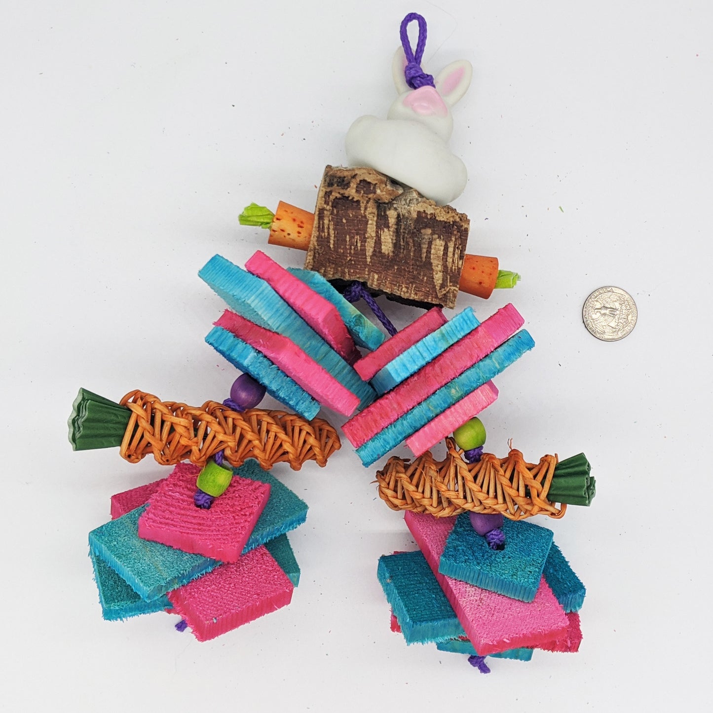 A vinyl rubber bunny sits on top of virgin cork bark, with cork stopper carrots. Includes thin and thick natural, kiln-dried pine slices and vine carrots. Great toy for small or medium birds and parrots, including conures, pionus, amazons, senegals, and more.