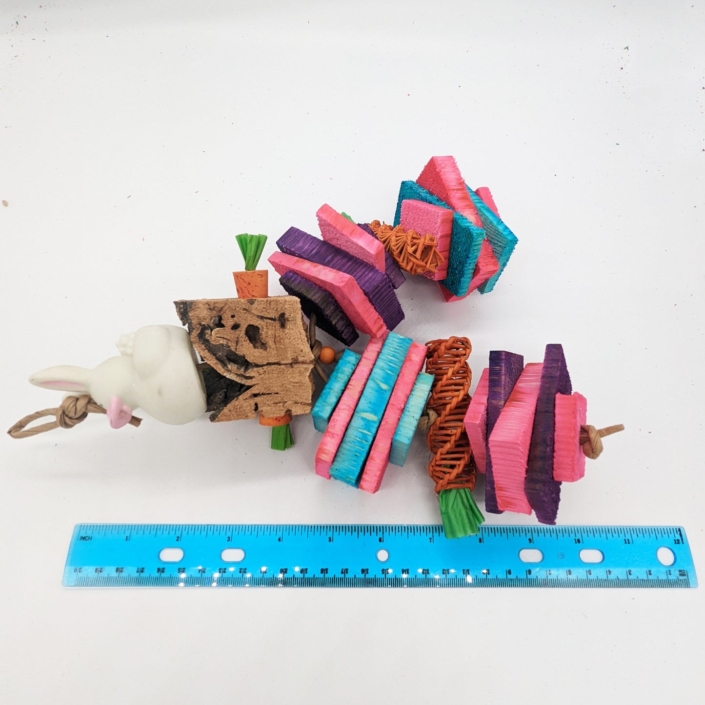 A vinyl rubber bunny sits on top of virgin cork bark, with cork stopper carrots. Includes thin and thick natural, kiln-dried pine slices and vine carrots. Great toy for small or medium birds and parrots, including conures, pionus, amazons, senegals, and more.