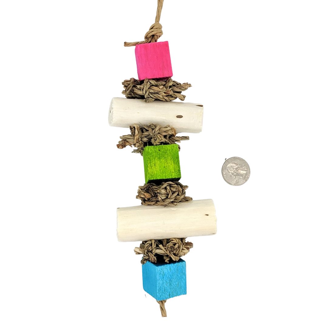 Balsa cubes and sola logs separated by seagrass squares on paper rope.
