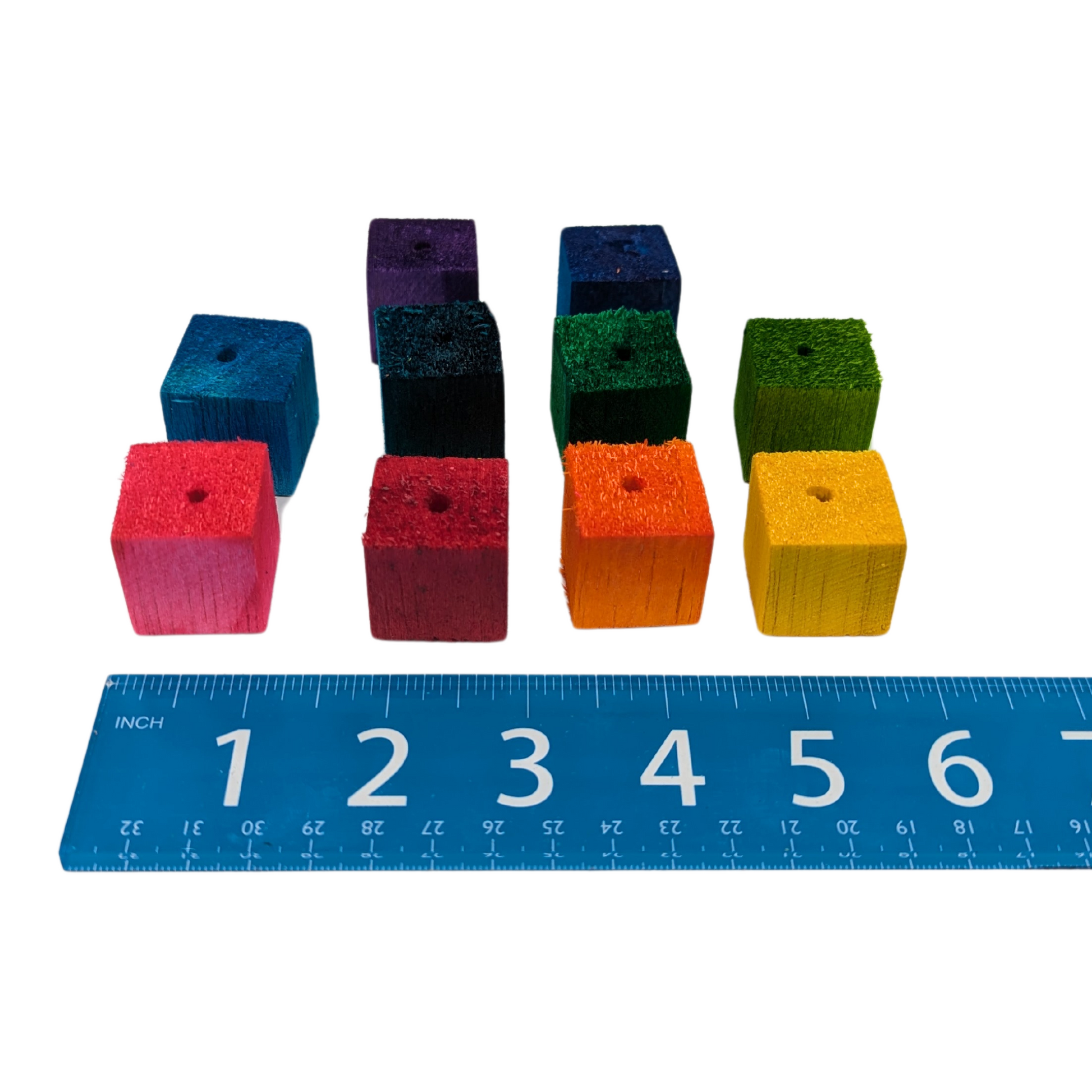 1 inch balsa cubes for making bird toys, lined up next to a ruler to show the 10 potential colors and scale