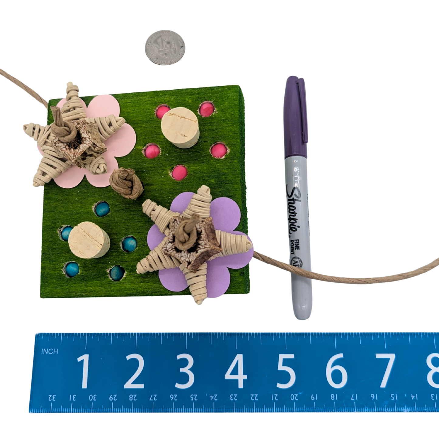 Dandy Parrot toy by Lil Monsters Bird Toys, next to a sharpie, ruler, and US quarter for scale, front view