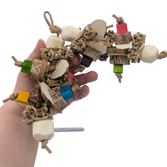 Frolic parrot toy by Lil Monsters Bird Toys, held in hand for scale