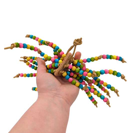 Medusa parrot toy by Lil Monsters Bird Toys, held in hand for scale