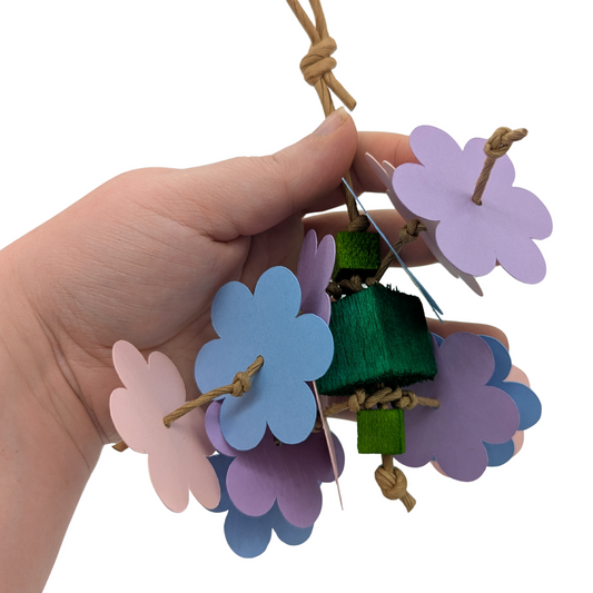 Mini Flower Shower parrot toy by Lil Monsters Bird Toys, held in hand for scale