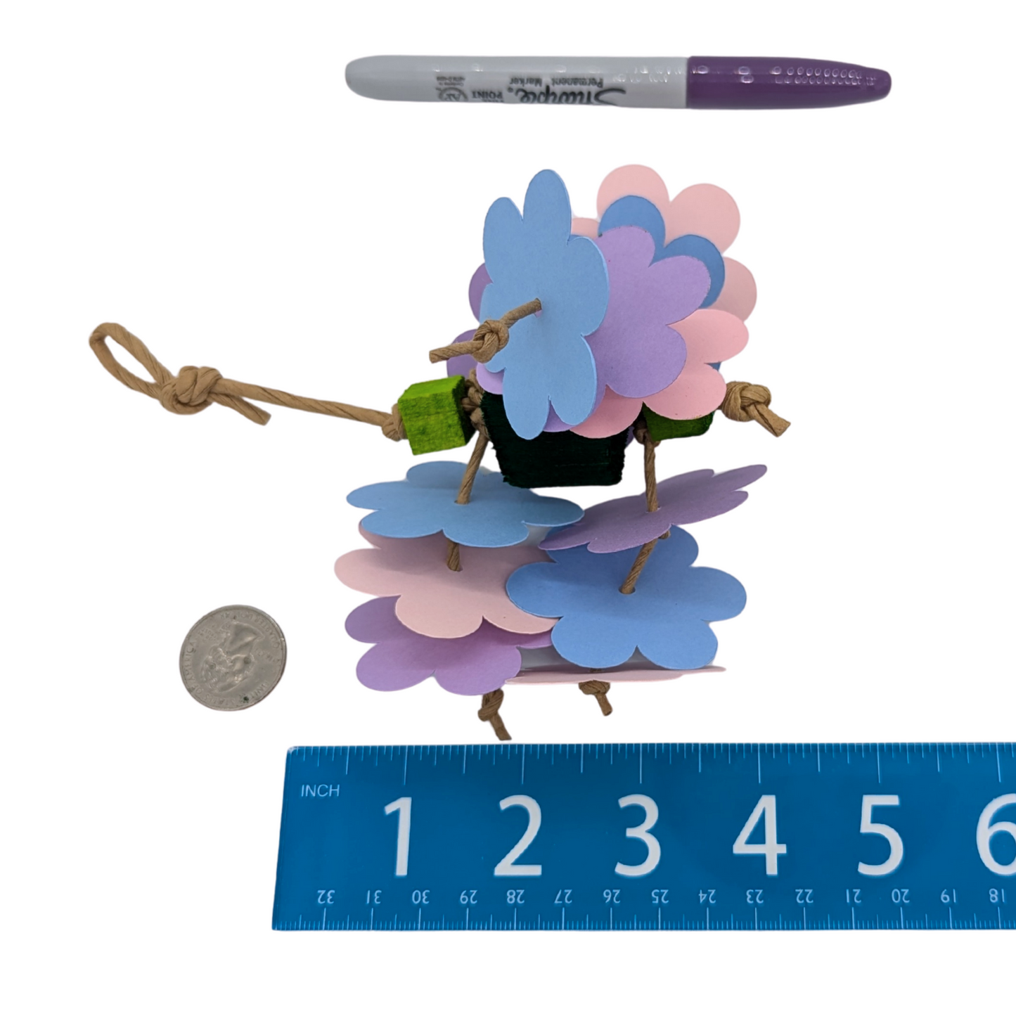Mini Flower Shower parrot toy by Lil Monsters Bird Toys, next to a sharpie, ruler, and US quarter for scale