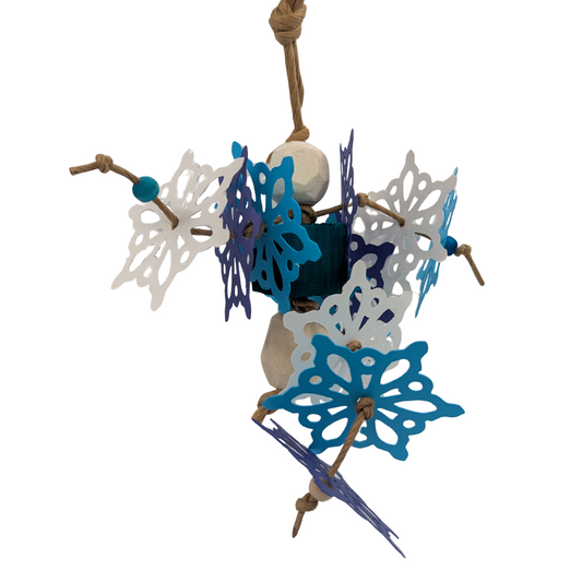 Bird toy with blue and white snowflakes,  sola balls, and a balsa cube on a white background. 