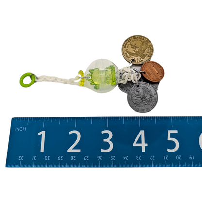 A Maneki Neko bird toy by Tiny Conure Trinkets, next to ruler for scale