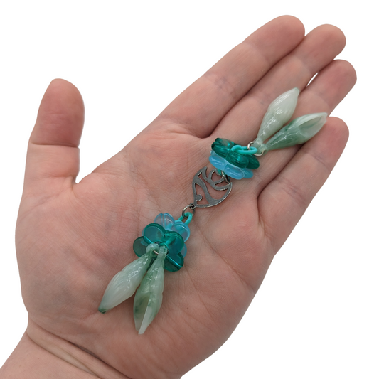 Seafoam bird foot toy by Tiny Conure Trinkets, held in hand for scale