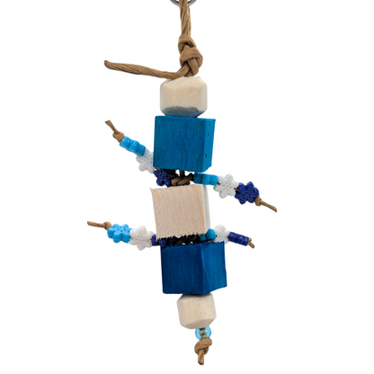 Bird toy with blue balsa blocks, sola rounds,, and plastic snowflake beads on a white background