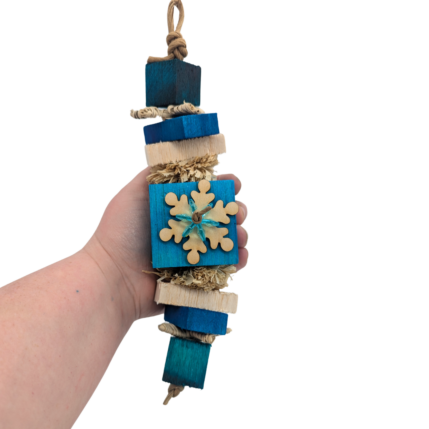 Squall winter themed bird toy by Lil Monsters Bird Toys, held in hand for scale