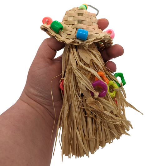 Straw Hat Preener bird toy by Super Bird Creations, held in hand for scale