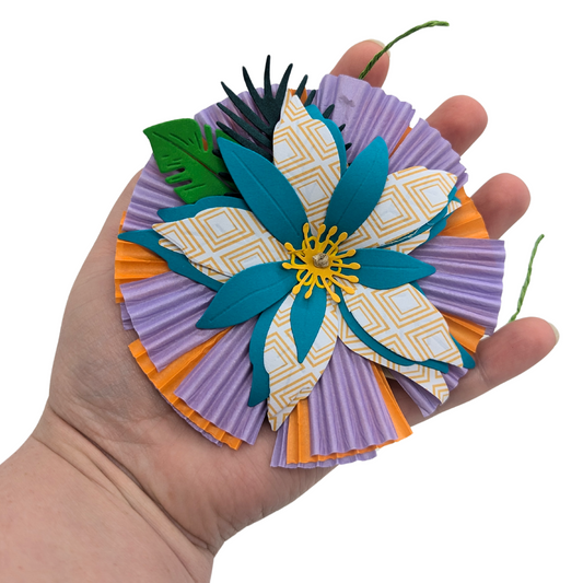 Wallflower parrot toy by Tiny Conure Trinkets, held in hand for scale