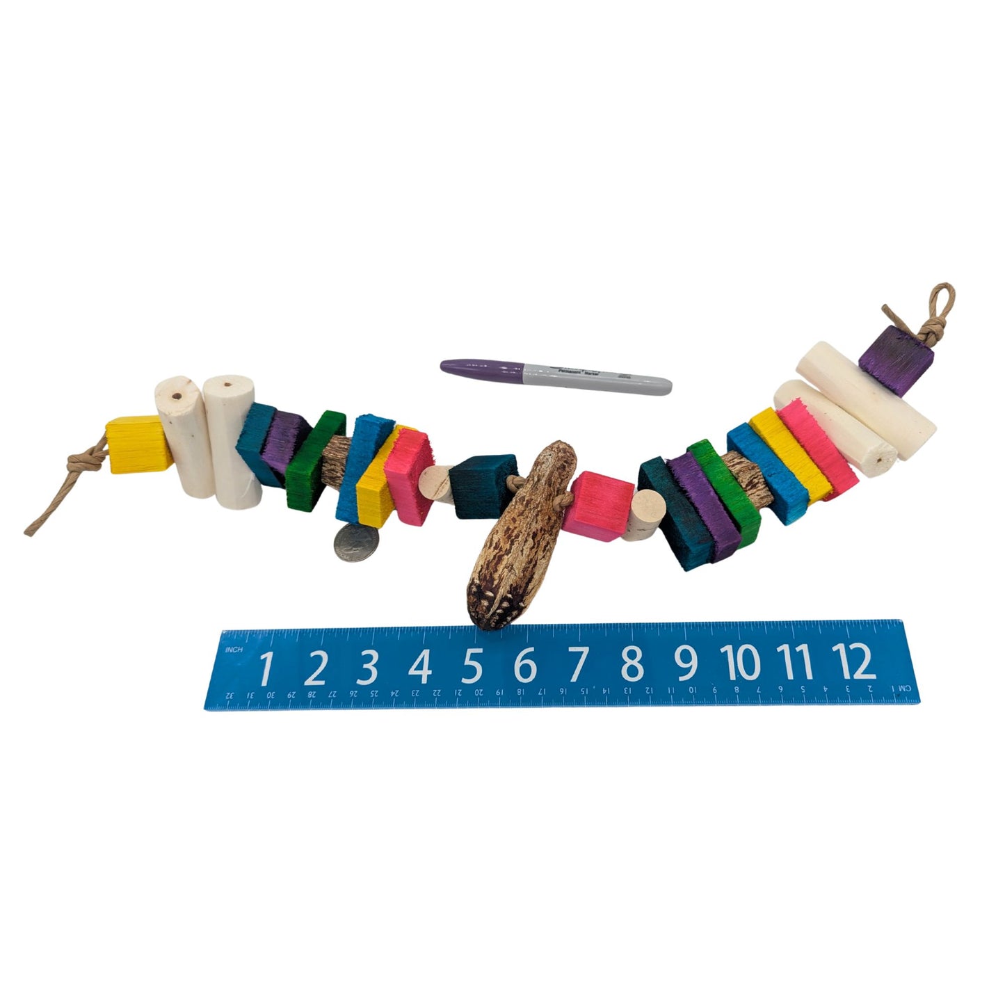 Balsa Garland by Lil Monsters Bird Toys. Shown unfolded next to a US quarter, Sharpie marker, and ruler for scale. 