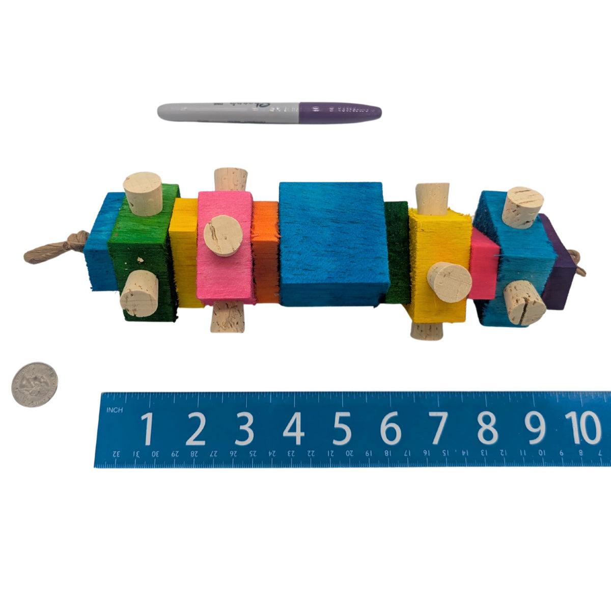Balsa Spire by Lil Monsters Bird Toys. Shown next to a US quarter, Sharpie marker, and ruler to show size. 