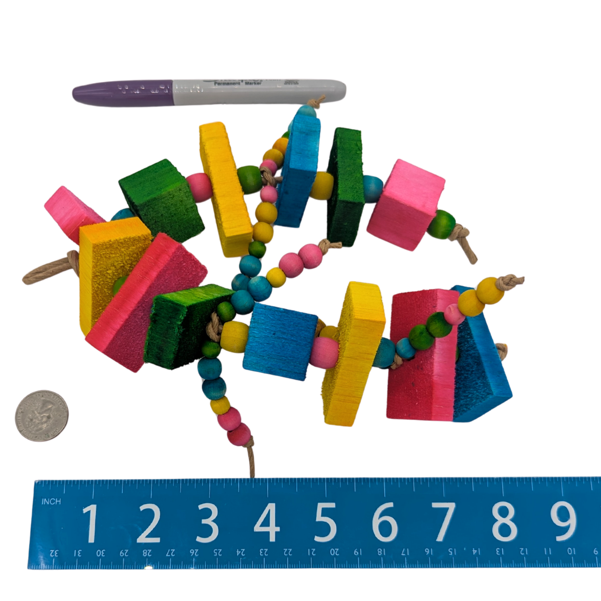 Balsa Triathlon by Lil Monsters Bird Toys. Next to ruler, US quarter, and a sharpie marker for scale. 