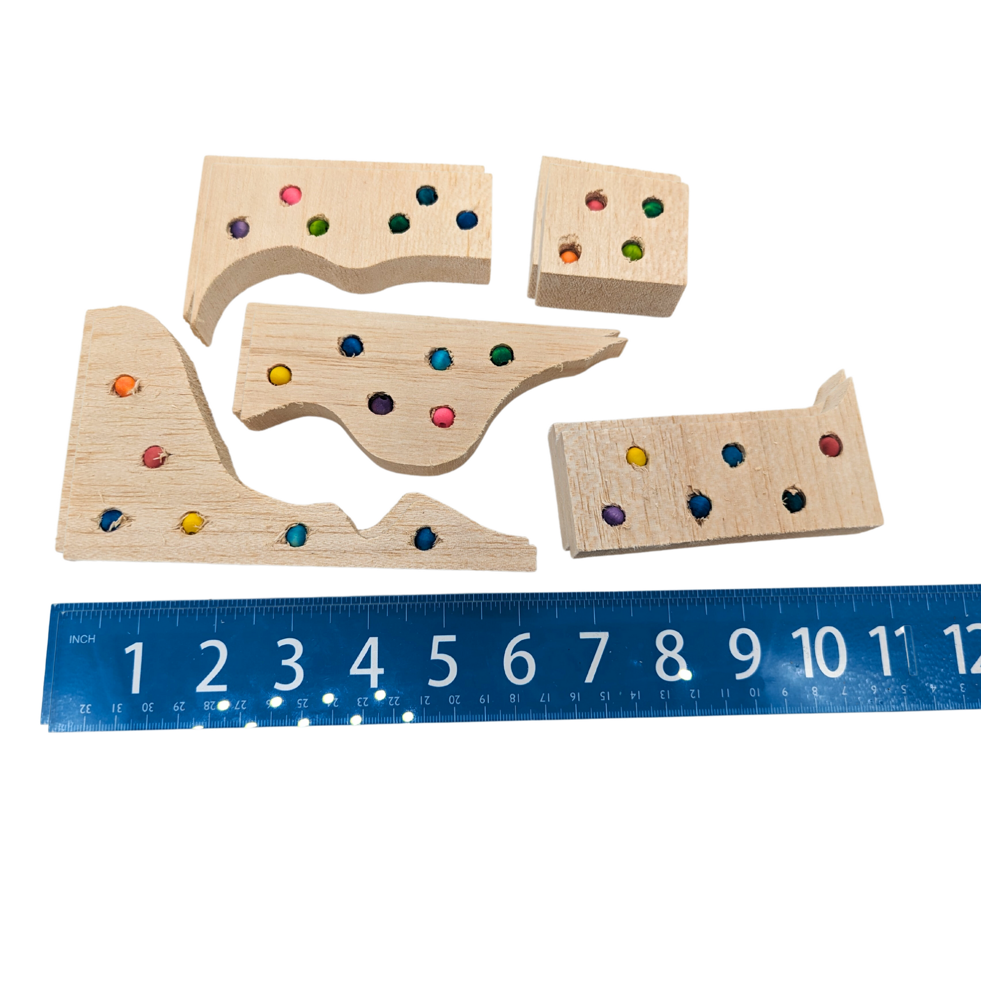 Balsa Waste Knots by Lil Monsters Bird Toys, several variations shown next to a ruler for scale