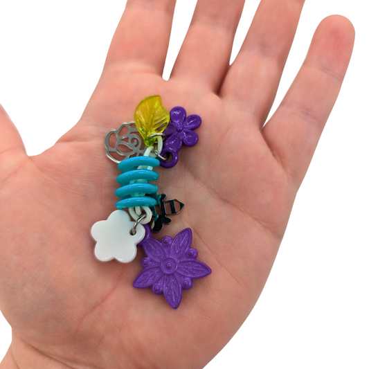 Bee's Garden Bird Toy by Tiny Conure Trinkets, held in hand for scale