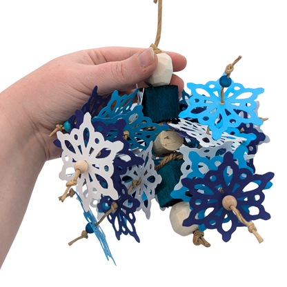 Blizzard Parrot toy by Lil Monsters Bird Toys, held in hand for scale