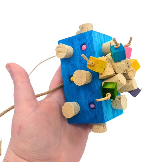 Blockbuster parrot toy by Lil Monsters Bird Toys, held in hand for scale