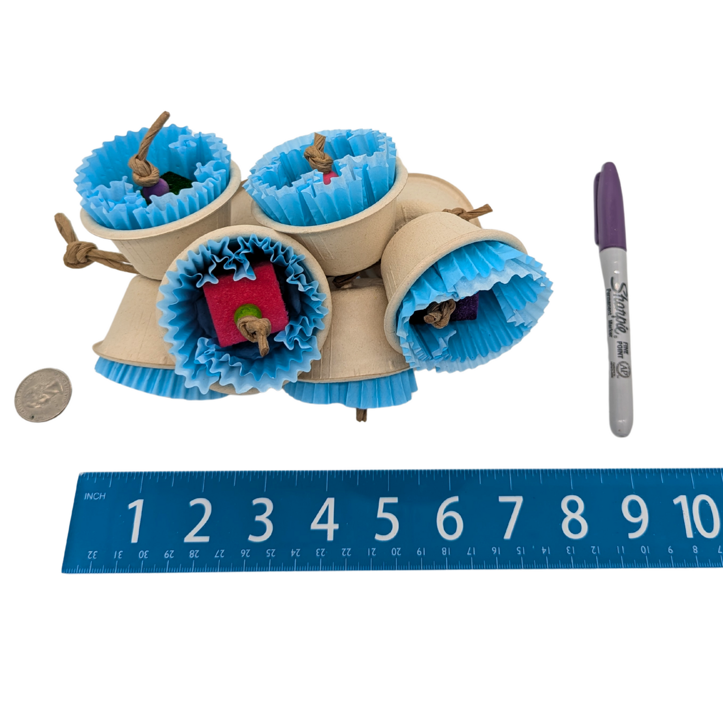 Bluebells bird toy by Lil Monsters Bird Toys, next to a sharpie, ruler, and US quarter for scale