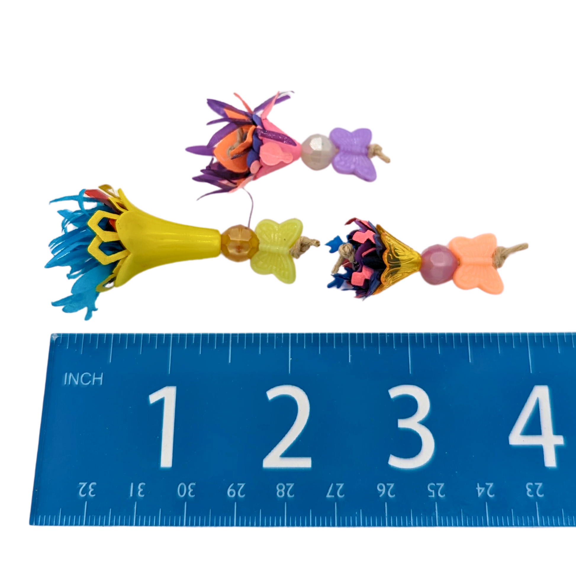 Bouquets 3 Pack bird foot toys by Tiny Conure Trinkets, next to a ruler for scale