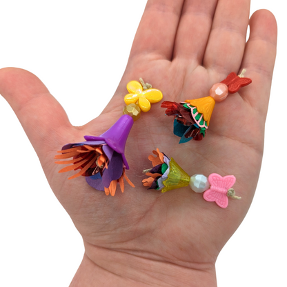 Bouquets 3 Pack bird foot toys by Tiny Conure Trinkets, in hand for scale