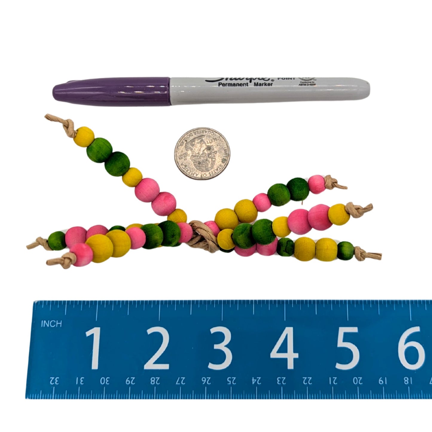 Bunch o' Peas by Lil Monsters Bird Toys. Next to a US quarter, sharpie marker, and ruler for scale. 