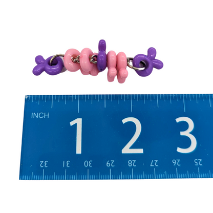 Bunny Twister foot toy for birds by Tiny Conure Trinkets, shown next to ruler for scale