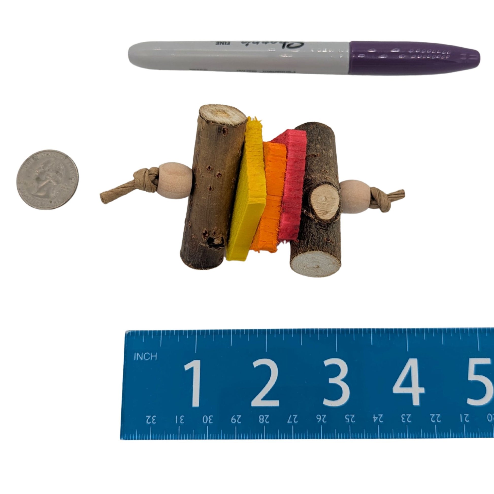 Cinder by Lil Monsters Bird Toys. Shown next to a US quarter, sharpie marker, and ruler for scale. 