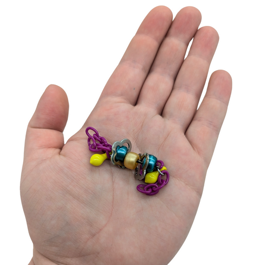 Fiddlin Sticks foot toy for birds by Tiny Conure Trinkets, in hand for scale