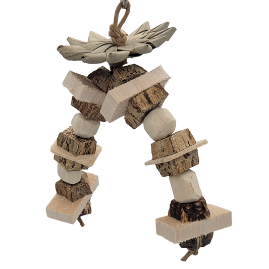 Hazel by Lil Monsters Bird Toys. Made with mahogany pod slices, balsa slats, sola, and pine slices, topped with a palm leaf flower. 