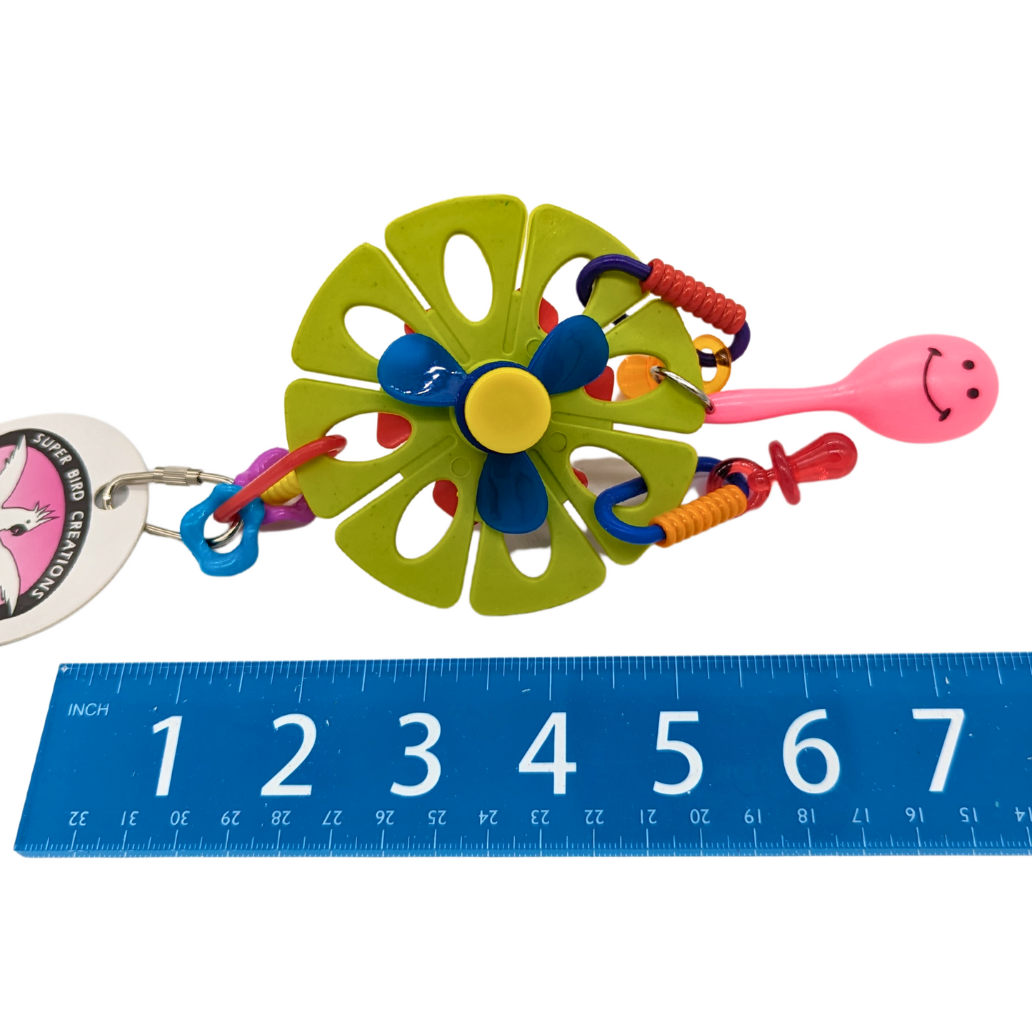 Maraca Flower bird toy by Super Bird Creations, next to ruler for scale