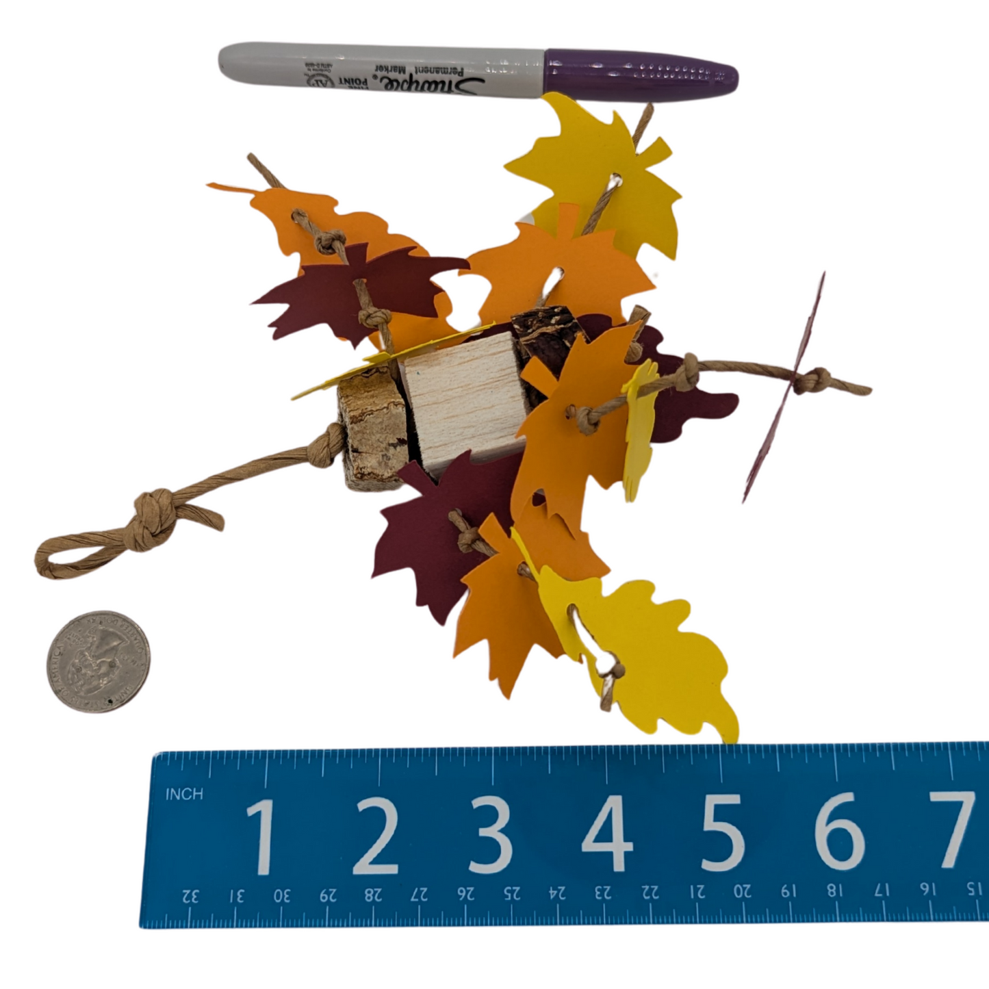 Mini Foliage parrot toy by Lil Monsters Bird Toys, next to a sharpie, ruler, and US quarter for scale